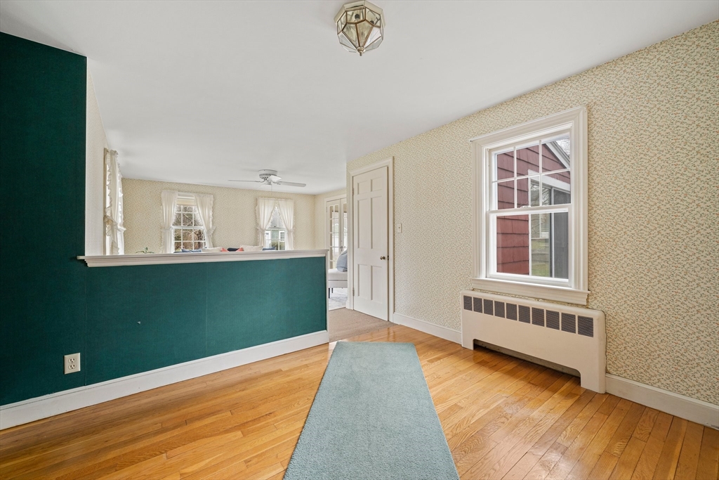 10 Robin Road Westwood, MA 02090 - Photo 17 of 37 a view of an empty room with wooden floor and a window