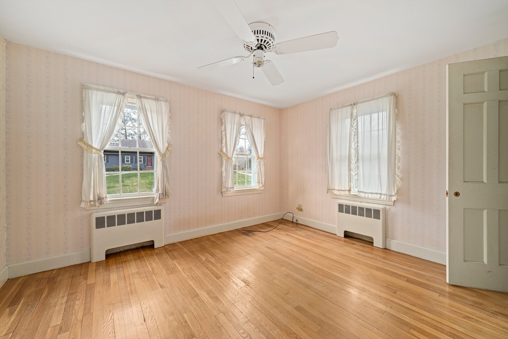 10 Robin Road Westwood, MA 02090 - Photo 22 of 37 a view of an empty room with a window and wooden floor
