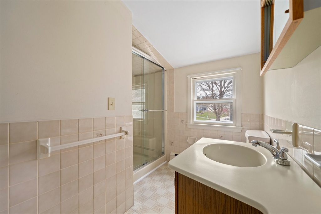 10 Robin Road Westwood, MA 02090 - Photo 29 of 37 a bathroom with a sink a shower and a mirror