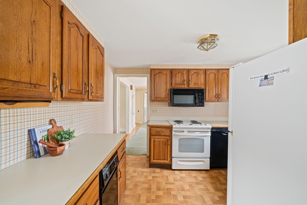10 Robin Road Westwood, MA 02090 - Photo 8 of 37 a kitchen with stainless steel appliances granite countertop a stove a sink and a microwave