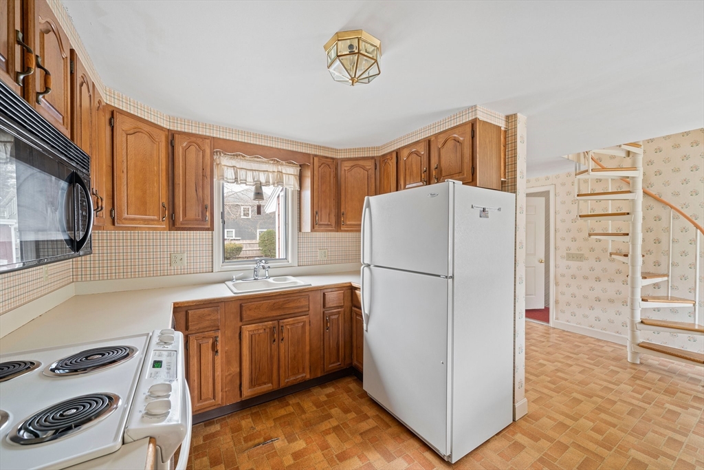 10 Robin Road Westwood, MA 02090 - Photo 9 of 37 a view of kitchen with stainless steel appliances granite countertop a refrigerator and a stove