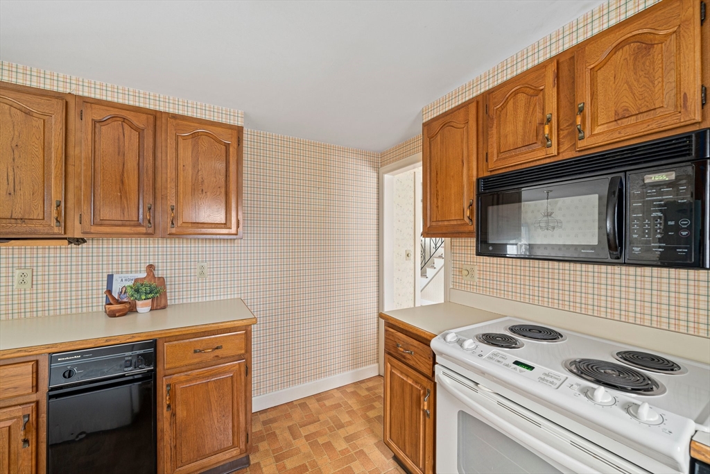 10 Robin Road Westwood, MA 02090 - Photo 10 of 37 a kitchen with stainless steel appliances granite countertop a stove microwave and cabinets