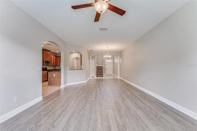 a kitchen with stainless steel appliances granite countertop a refrigerator and a stove top oven