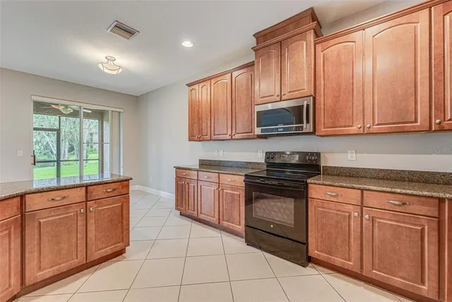 an empty room with a window and a ceiling fan