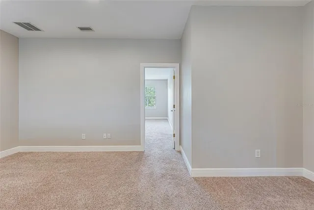 a spacious bathroom with a granite countertop double vanity sink a mirror and a bathtub