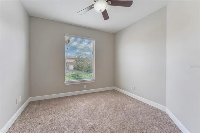 an aerial view of a city with lots of residential buildings ocean and mountain view in back