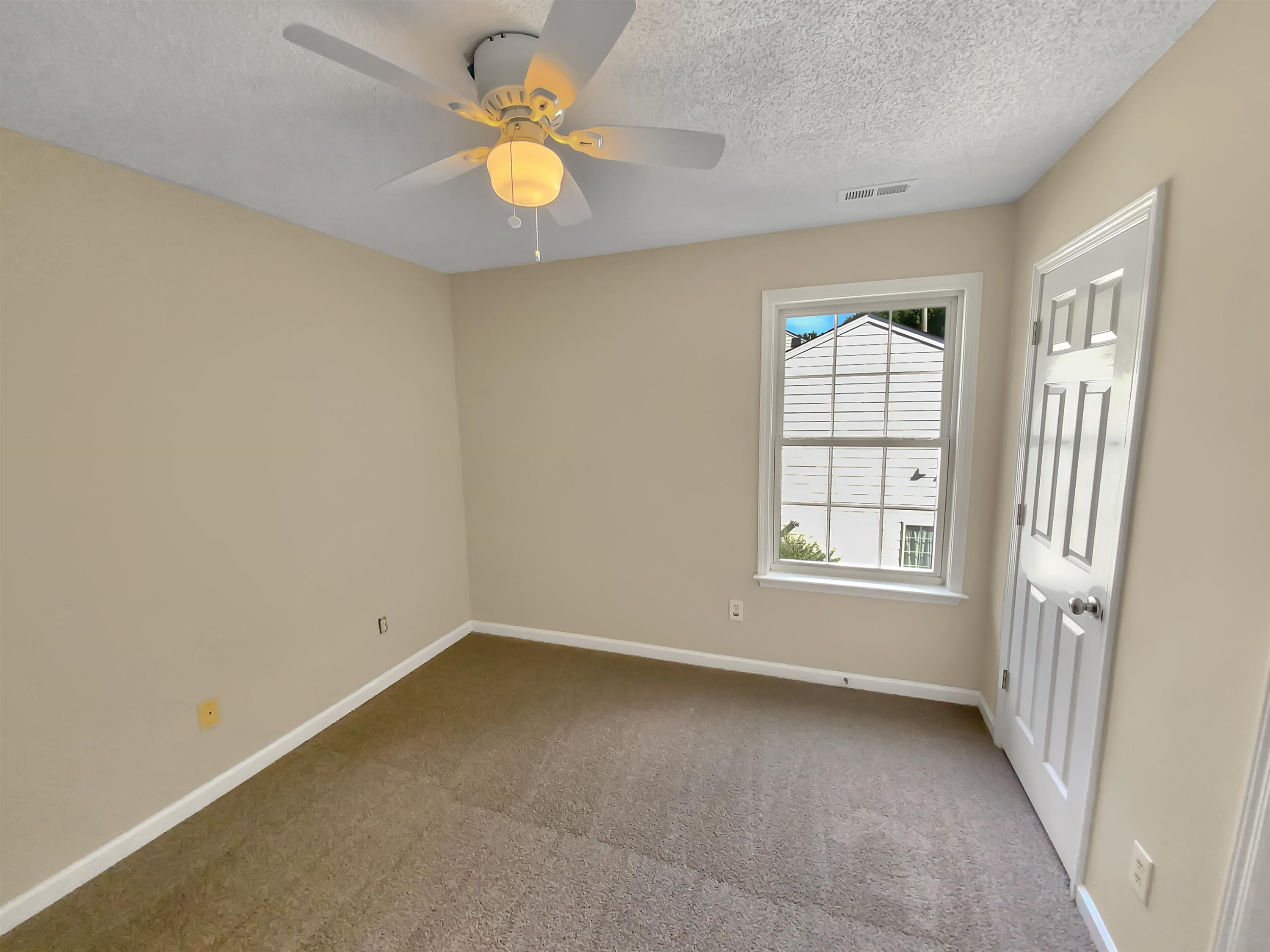113 Brierridge Drive Apex, NC 27502 - Photo 9 of 20 an empty room with windows and ceiling fan