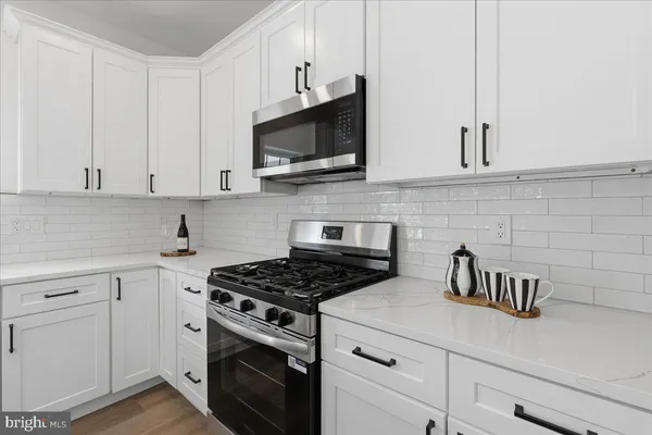a kitchen with cabinets stainless steel appliances and a sink