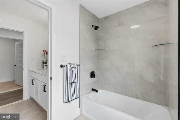 a bathroom with a bathtub and a shower