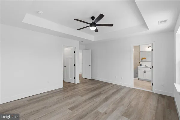 a view of a room with wooden floor and white walls