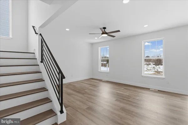 a view of entryway and hall with wooden floor