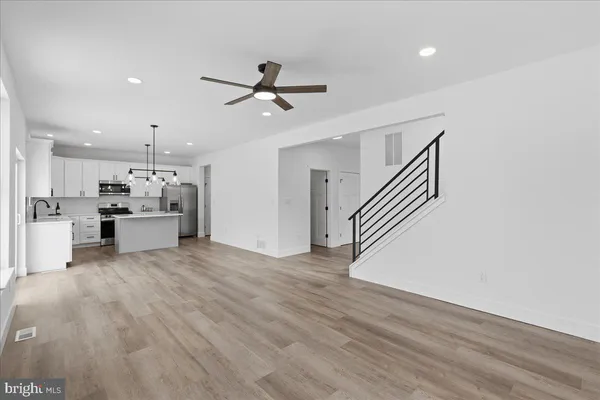 a view of kitchen with furniture and wooden floor