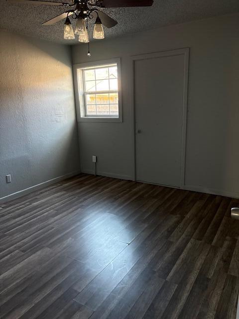 2316 38th Street Lubbock, TX 79412 - Photo 5 of 11 an empty room with wooden floor chandelier fan and windows