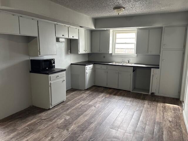 2316 38th Street Lubbock, TX 79412 - Photo 6 of 11 a kitchen with granite countertop a sink cabinets and stainless steel appliances