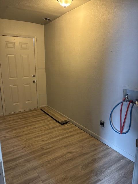 2316 38th Street Lubbock, TX 79412 - Photo 9 of 11 a view of a room with wooden floor and bench