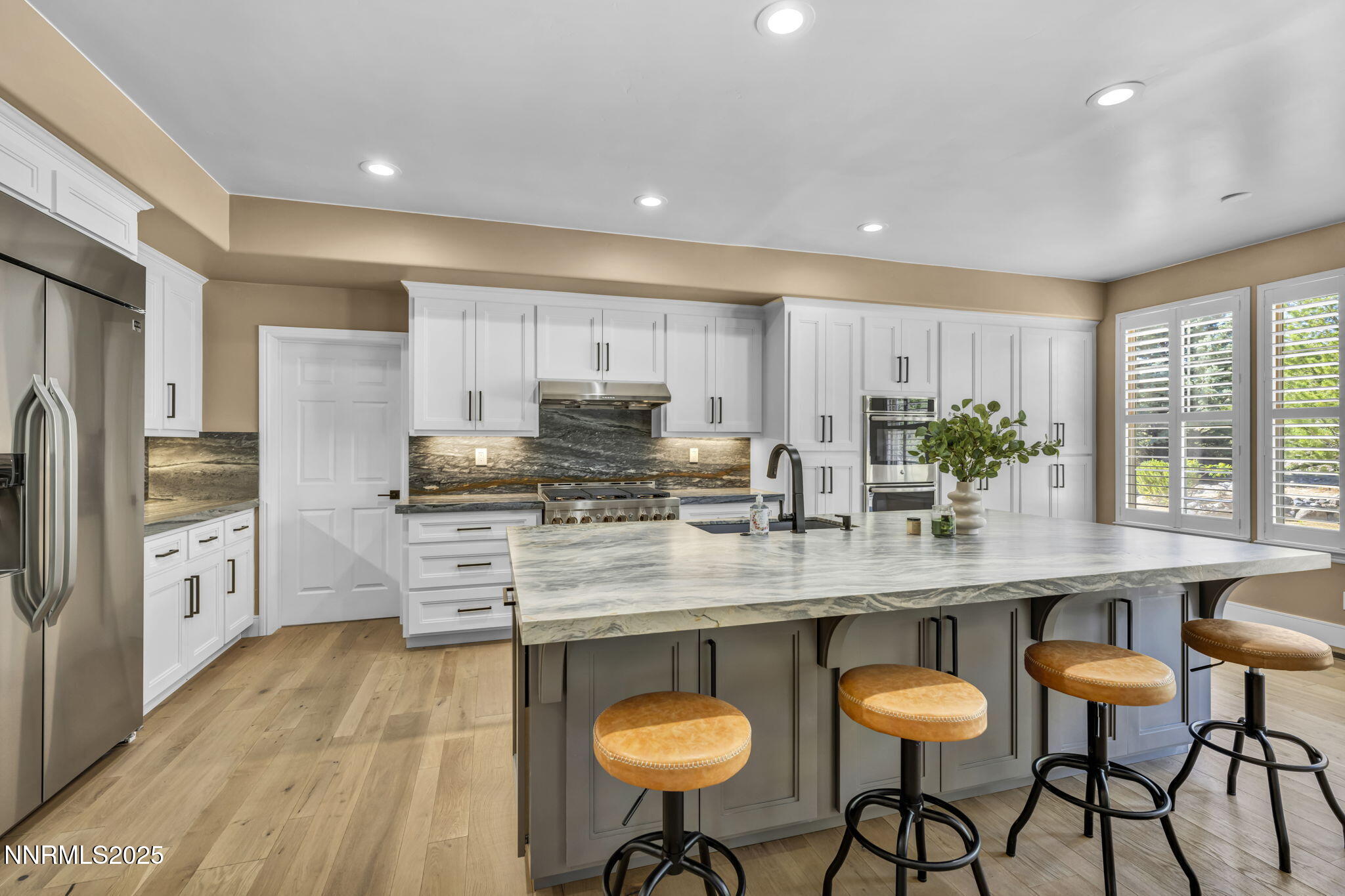 2965 Roundrock Court Reno, NV 89511 - Photo 77 of 119 a kitchen with stainless steel appliances granite countertop a table chairs sink refrigerator and cabinets