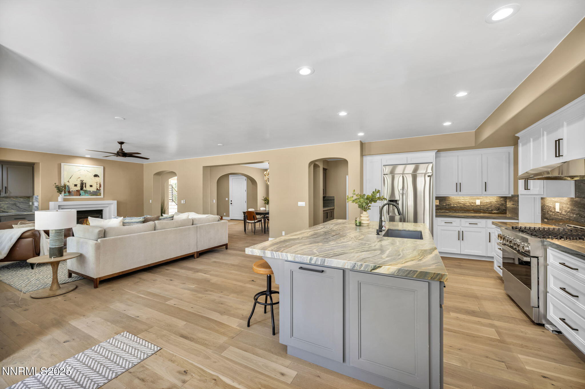 2965 Roundrock Court Reno, NV 89511 - Photo 80 of 119 a large white kitchen with sink stove and white cabinets with wooden floor