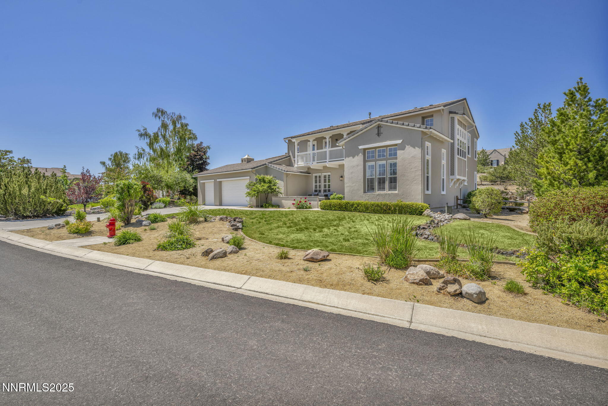 2965 Roundrock Court Reno, NV 89511 - Photo 94 of 119 a front view of a house with a yard and potted plants