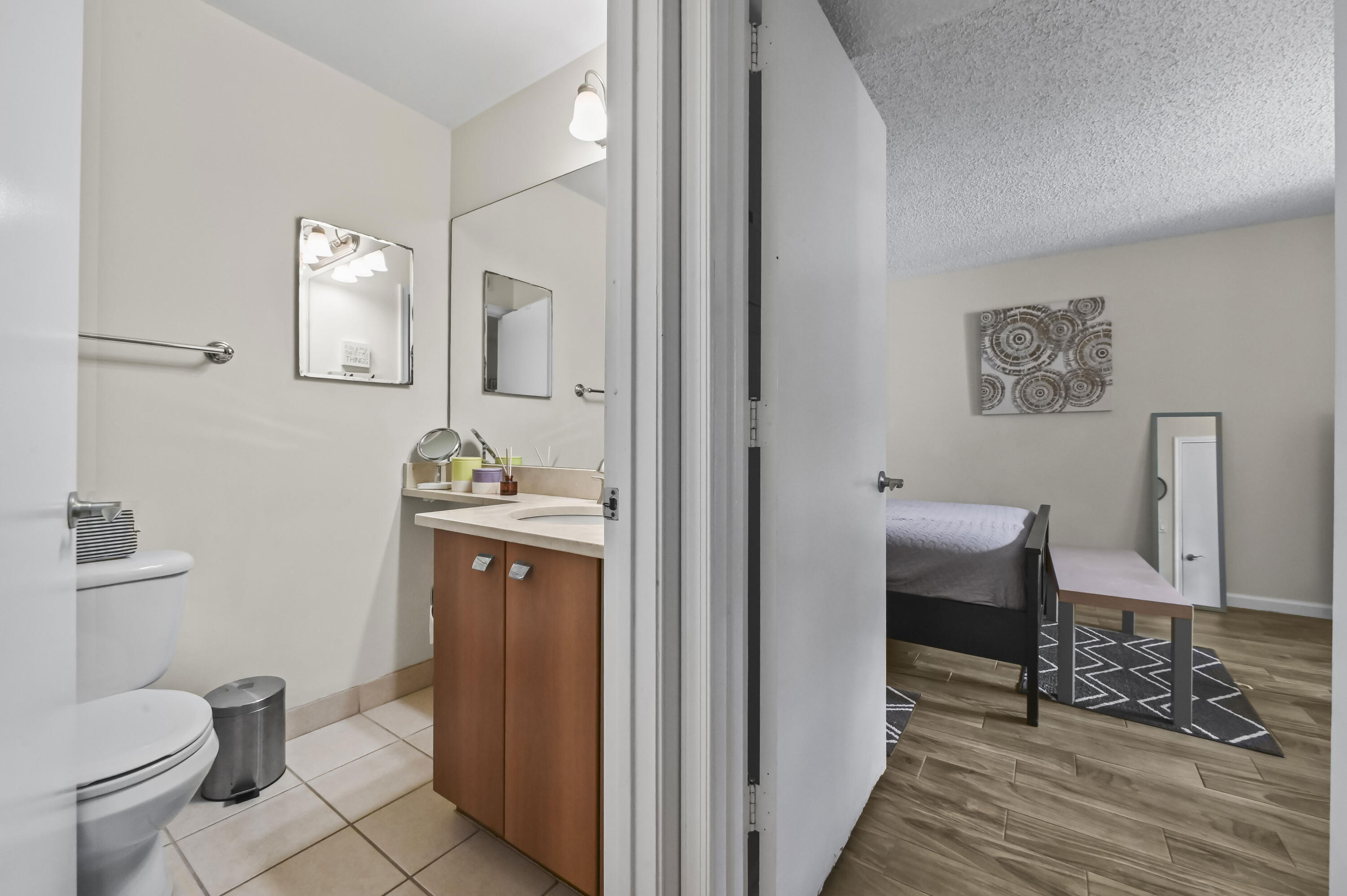 1205 Crystal Way, Unit K Delray Beach, FL 33444 - Photo 12 of 25 a bathroom with a toilet a sink and mirror