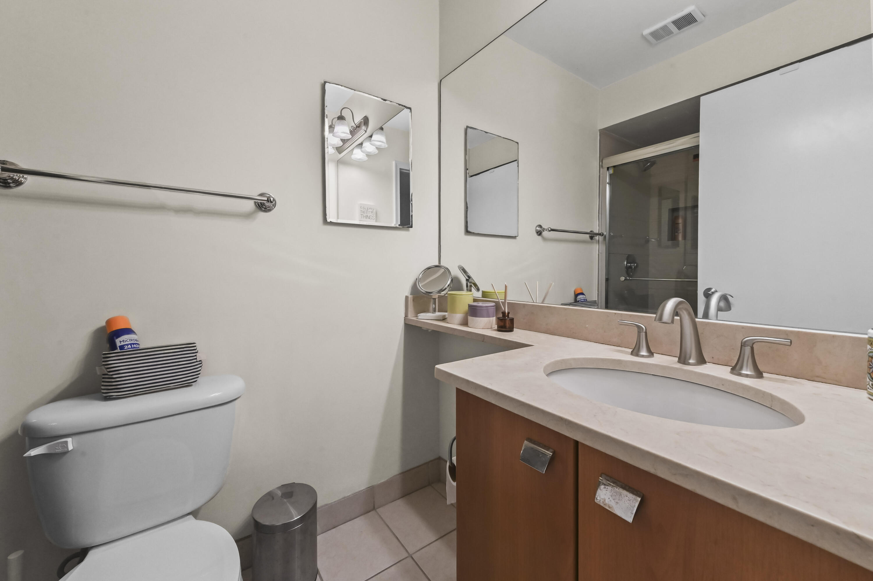 1205 Crystal Way, Unit K Delray Beach, FL 33444 - Photo 13 of 25 a bathroom with a sink vanity mirror and toilet