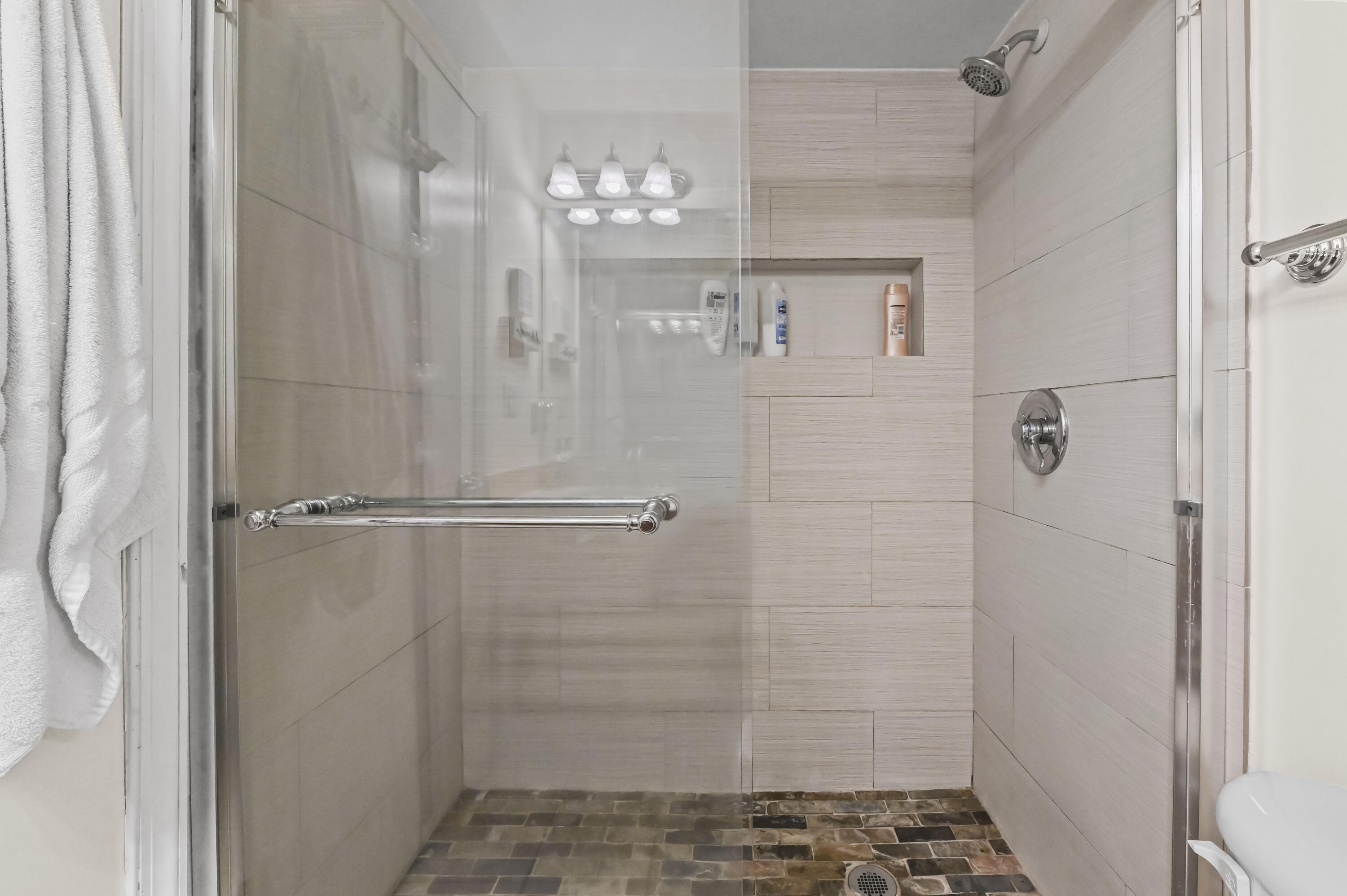 1205 Crystal Way, Unit K Delray Beach, FL 33444 - Photo 14 of 25 a bathroom with a glass shower door