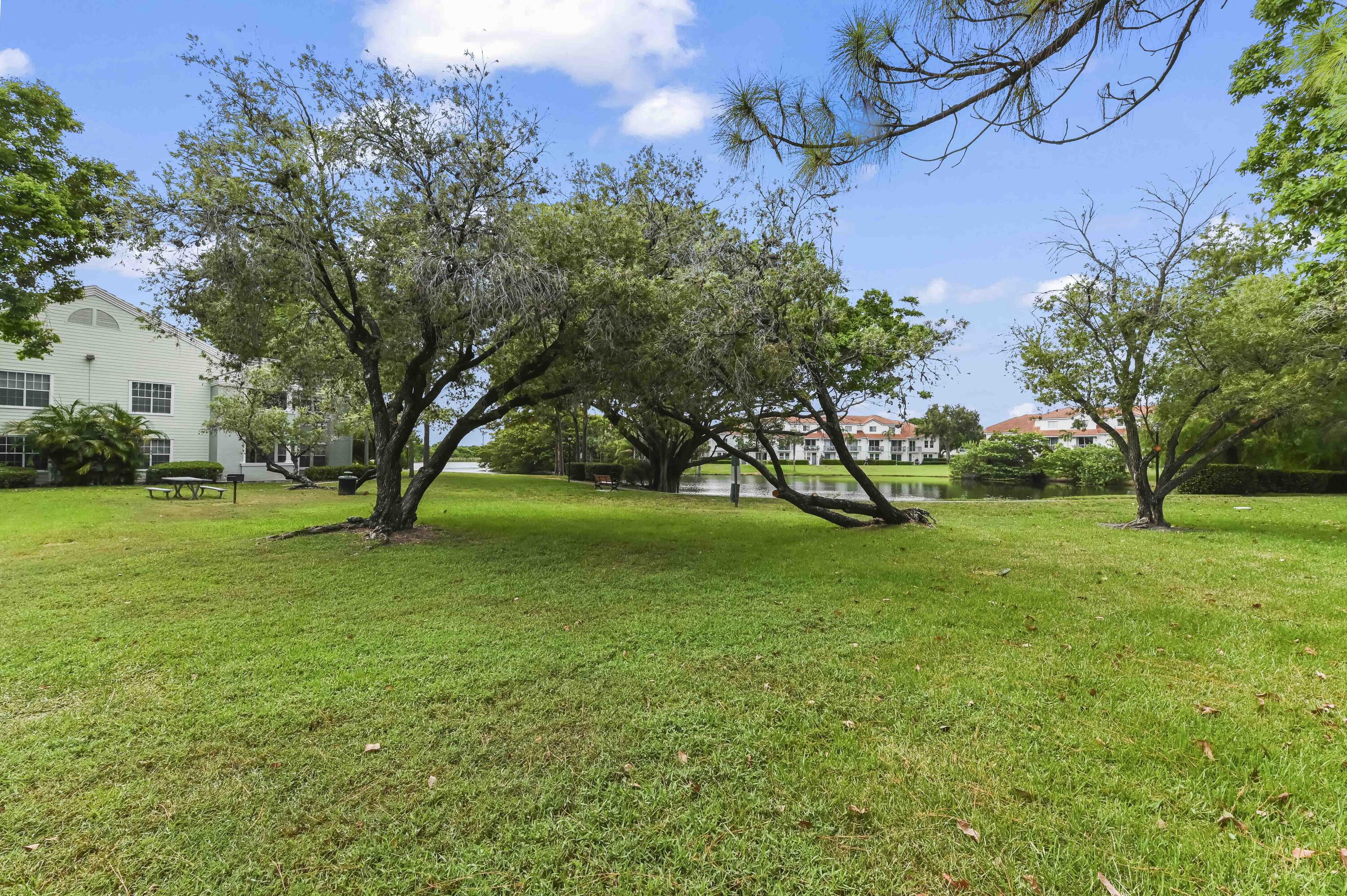 1205 Crystal Way, Unit K Delray Beach, FL 33444 - Photo 19 of 25 a view of a yard with plants and trees