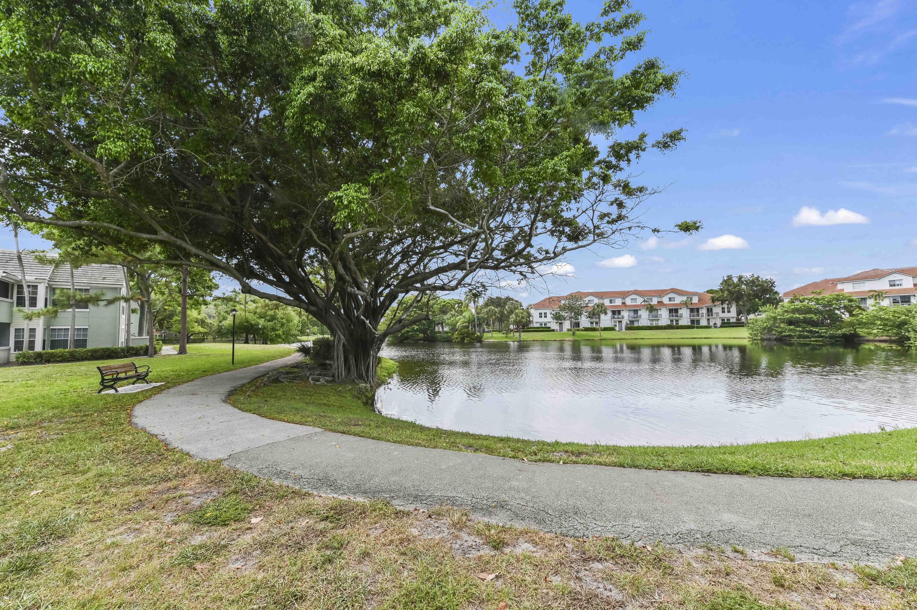 1205 Crystal Way, Unit K Delray Beach, FL 33444 - Photo 20 of 25 a swimming pool with outdoor seating and yard
