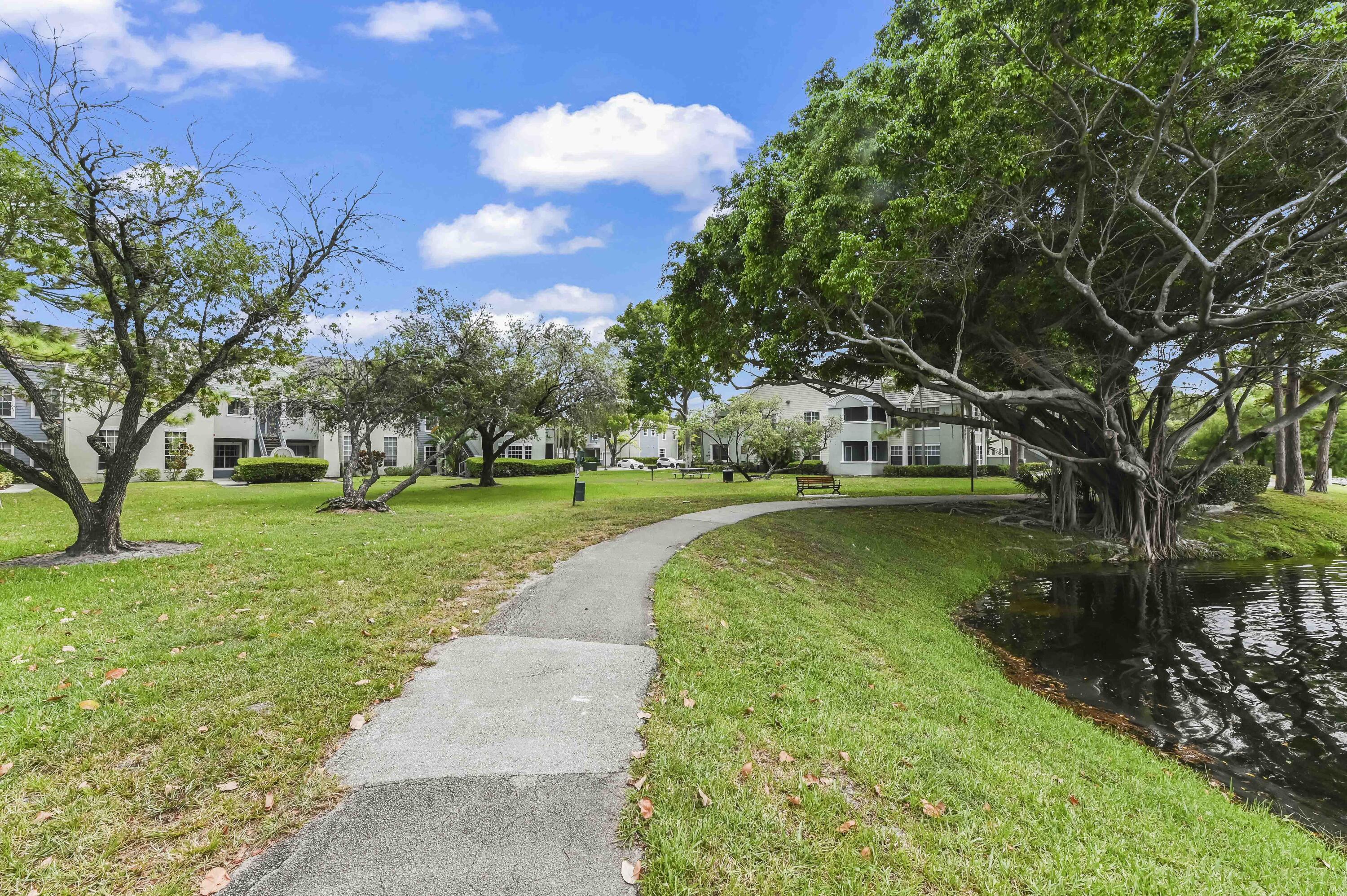 1205 Crystal Way, Unit K Delray Beach, FL 33444 - Photo 21 of 25 a view of a garden with houses