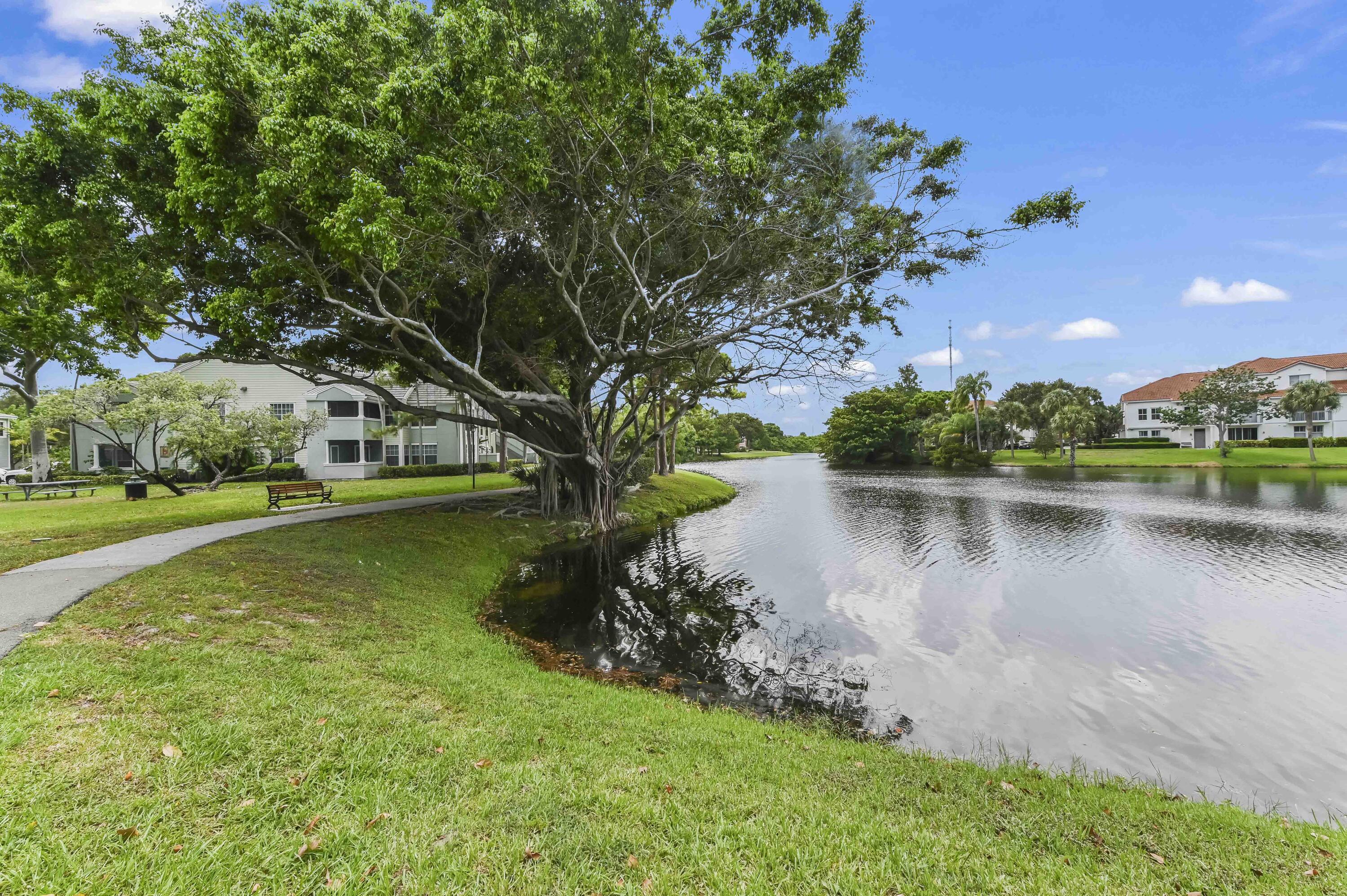 1205 Crystal Way, Unit K Delray Beach, FL 33444 - Photo 22 of 25 a view of a lake with houses