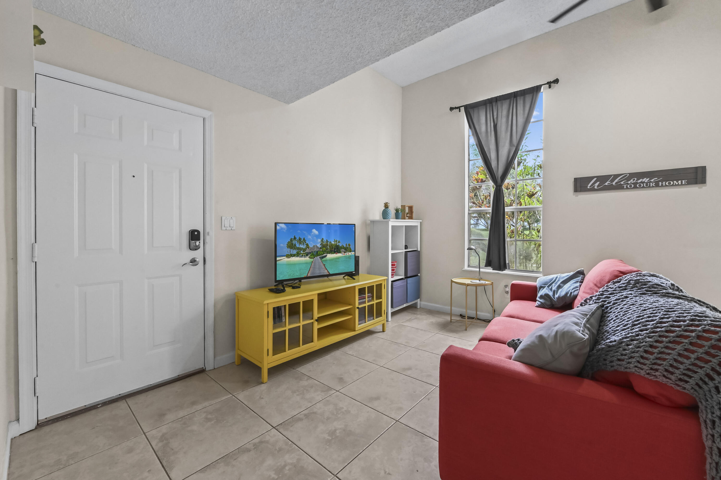 1205 Crystal Way, Unit K Delray Beach, FL 33444 - Photo 6 of 25 a living room with furniture and a flat screen tv