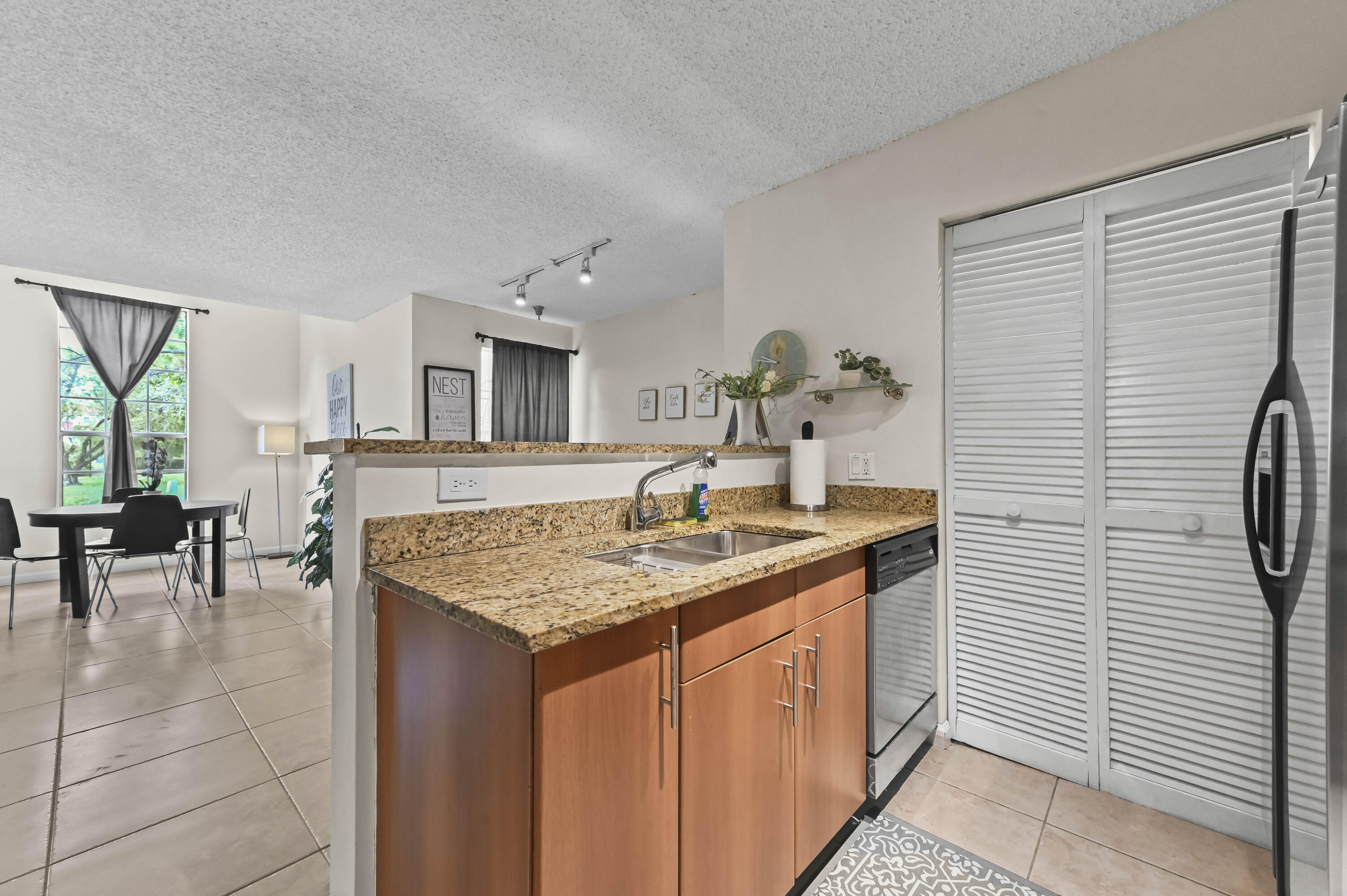 1205 Crystal Way, Unit K Delray Beach, FL 33444 - Photo 10 of 25 a bathroom with a granite countertop sink and a mirror