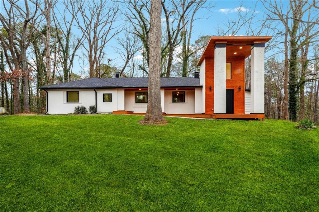 a front view of house with yard and green space
