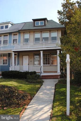 1403 Foxhall Road Northwest Washington, DC 20007 - Photo 1 of 22 a front view of a house with a yard