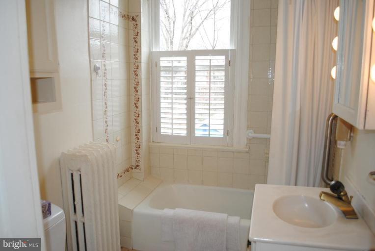 1403 Foxhall Road Northwest Washington, DC 20007 - Photo 14 of 22 a bathroom with a sink and a bathtub