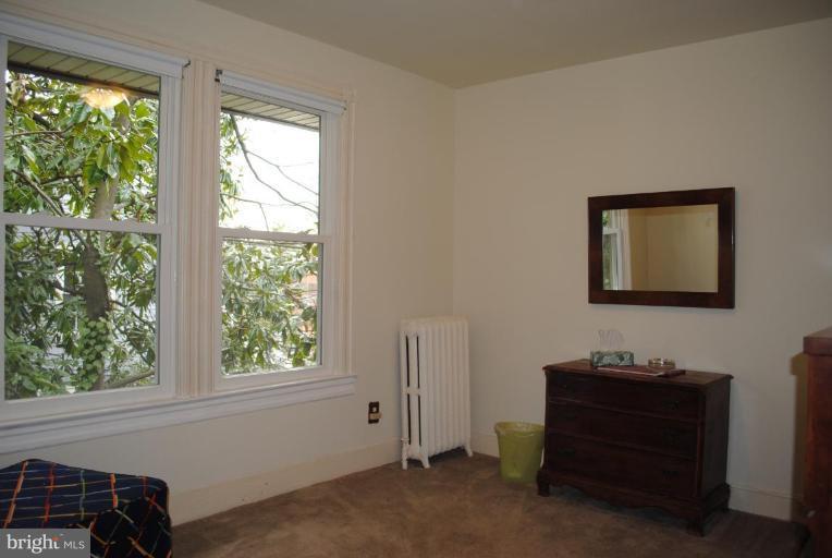 1403 Foxhall Road Northwest Washington, DC 20007 - Photo 16 of 22 a living room with furniture and a window