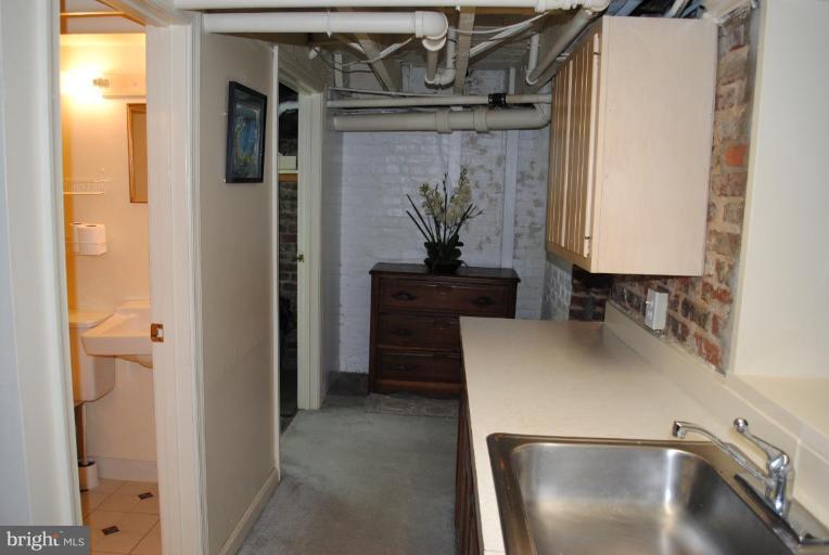 1403 Foxhall Road Northwest Washington, DC 20007 - Photo 18 of 22 a kitchen with a refrigerator and a sink