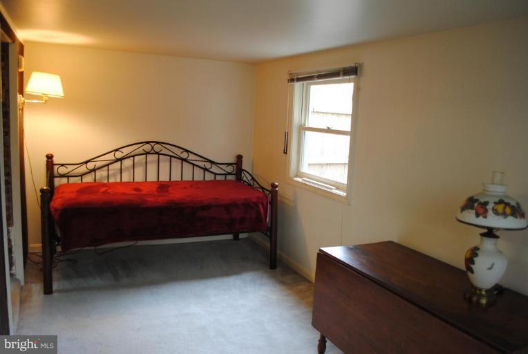 1403 Foxhall Road Northwest Washington, DC 20007 - Photo 22 of 22 a bed sitting in a bedroom next to a window