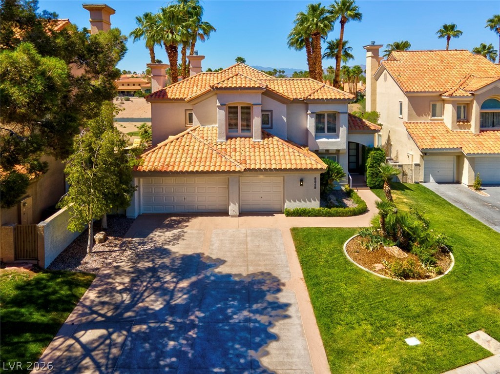 8848 Rainbow Ridge Drive Las Vegas, NV 89117 - Photo 41 of 43 A well-maintained lawn and driveway lead to this appealing residence, crowned with a terracotta-tiled roof.