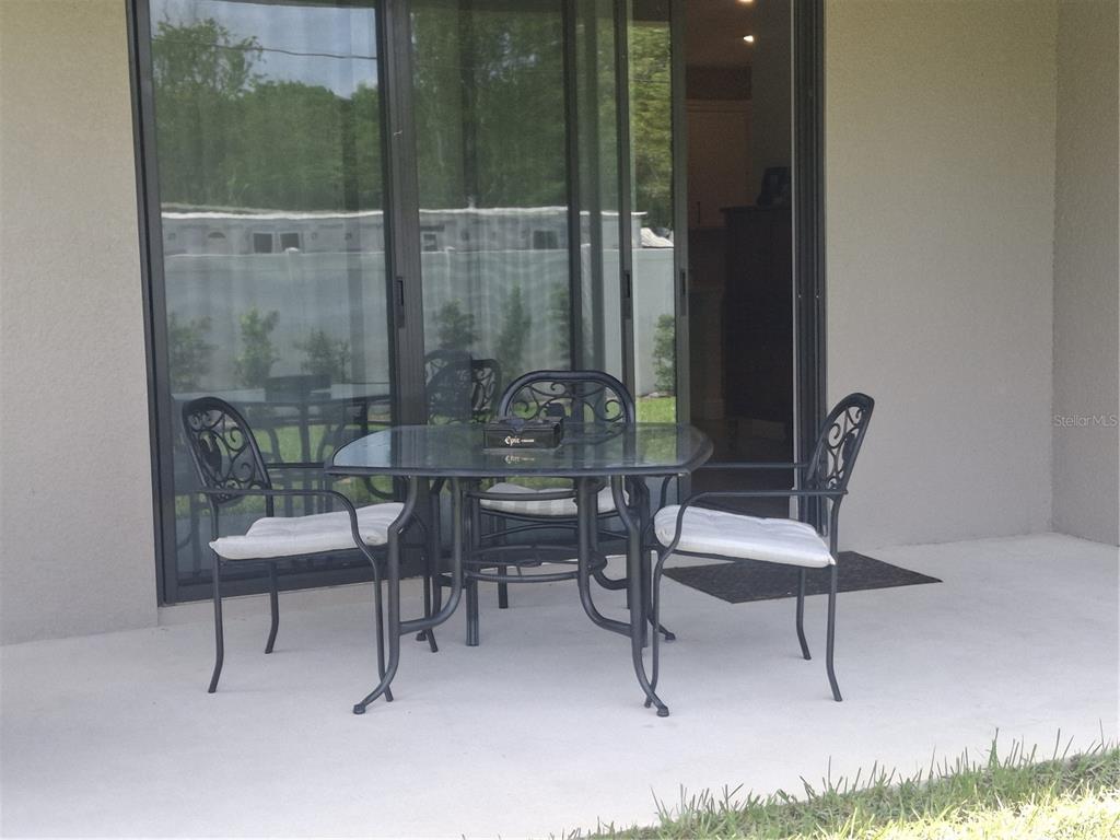 12618 Vander Way New Port Richey, FL 34654 - Photo 22 of 22 a view of a room with a table and chairs
