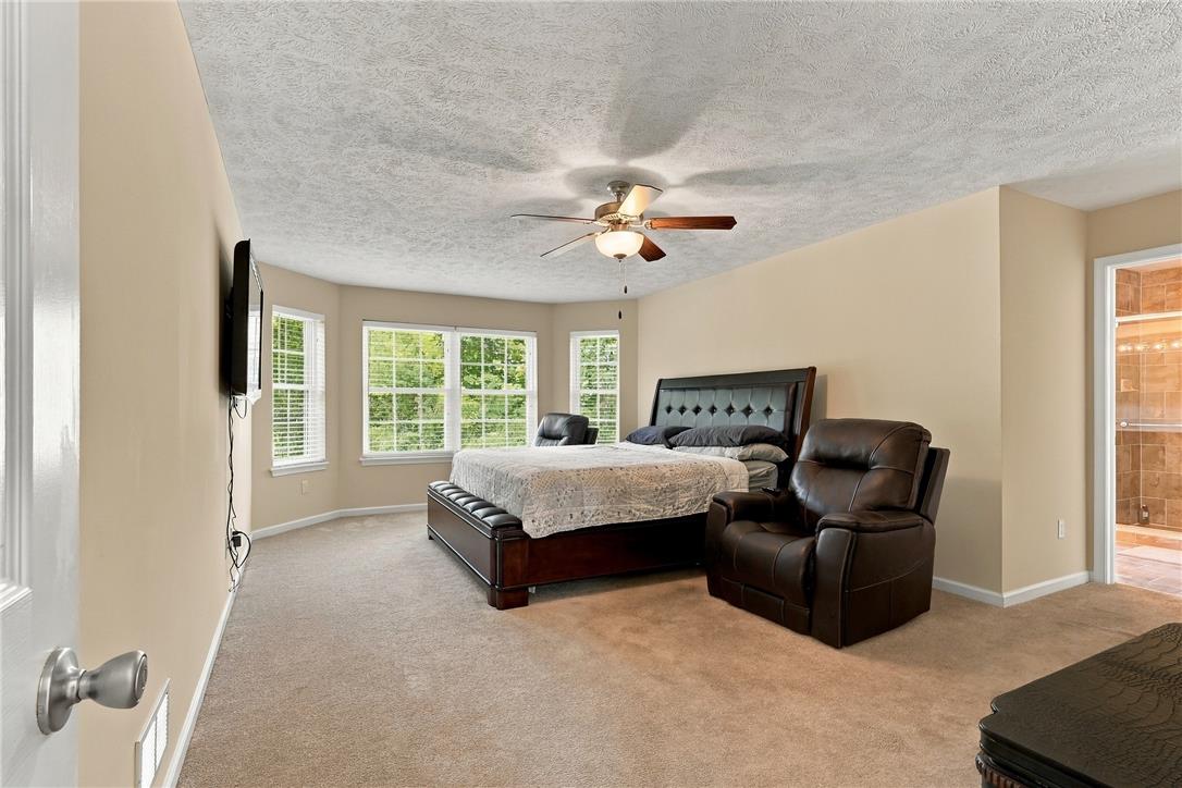 1657 Rachel Road Stroudsburg, PA 18360 - Photo 21 of 46 A spacious bedroom features neutral walls, wall-to-wall carpeting, and multiple windows providing natural light.