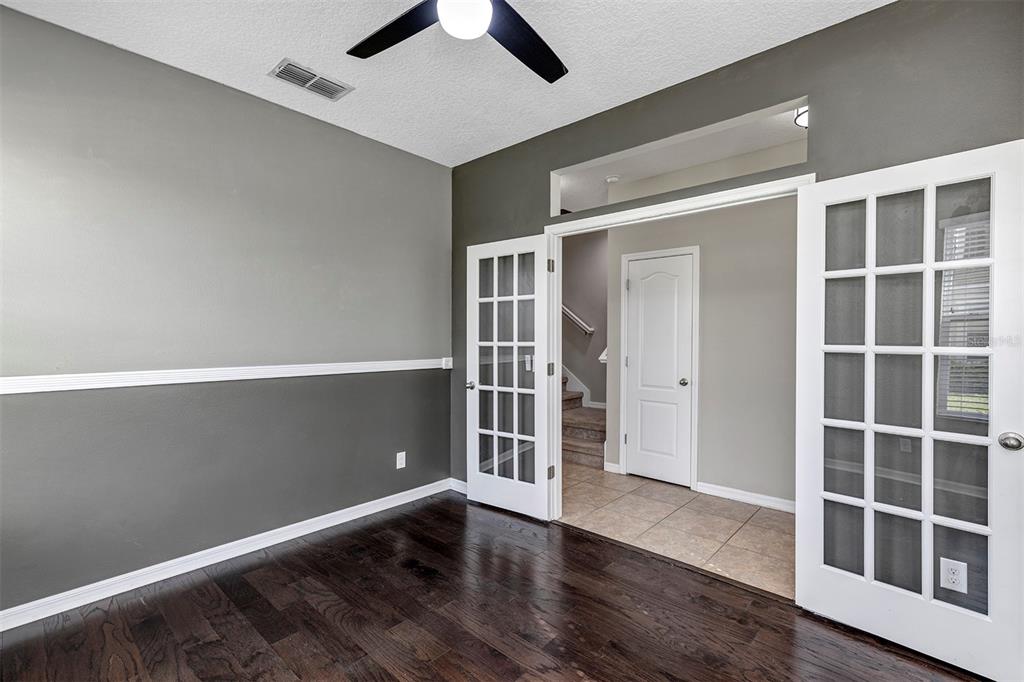 7644 Ripplepointe Way Windermere, FL 34786 - Photo 17 of 52 an empty room with wooden floor and windows