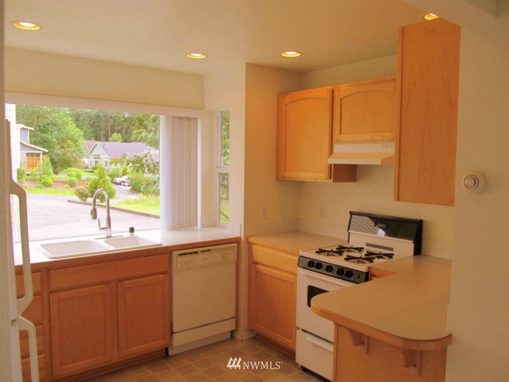 805 Blueberry Lane Bellingham, WA 98229 - Photo 3 of 15 a kitchen with a sink a stove cabinets and a window