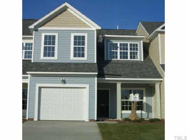 7306 Caversham Way Raleigh, NC 27617 - Photo 1 of 6 a front view of a house with a yard