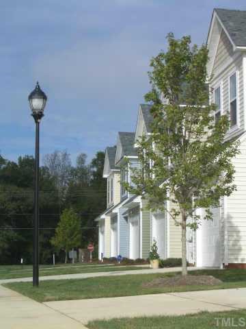 7306 Caversham Way Raleigh, NC 27617 - Photo 2 of 6 a front view of a building with a garden