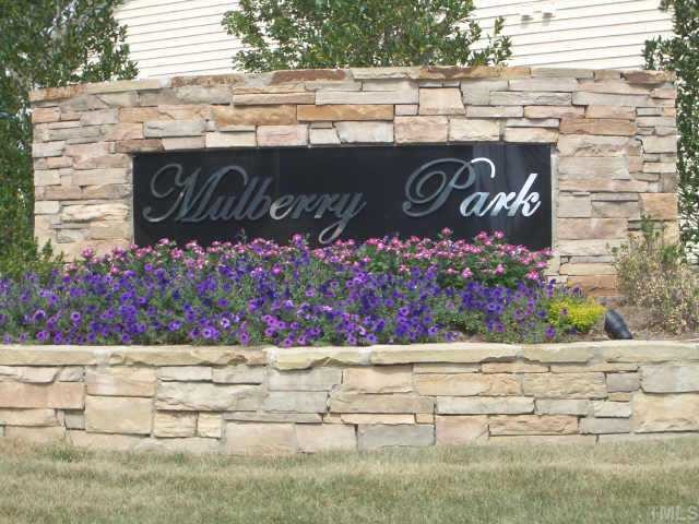 7306 Caversham Way Raleigh, NC 27617 - Photo 3 of 6 a wooden sign on the side of building
