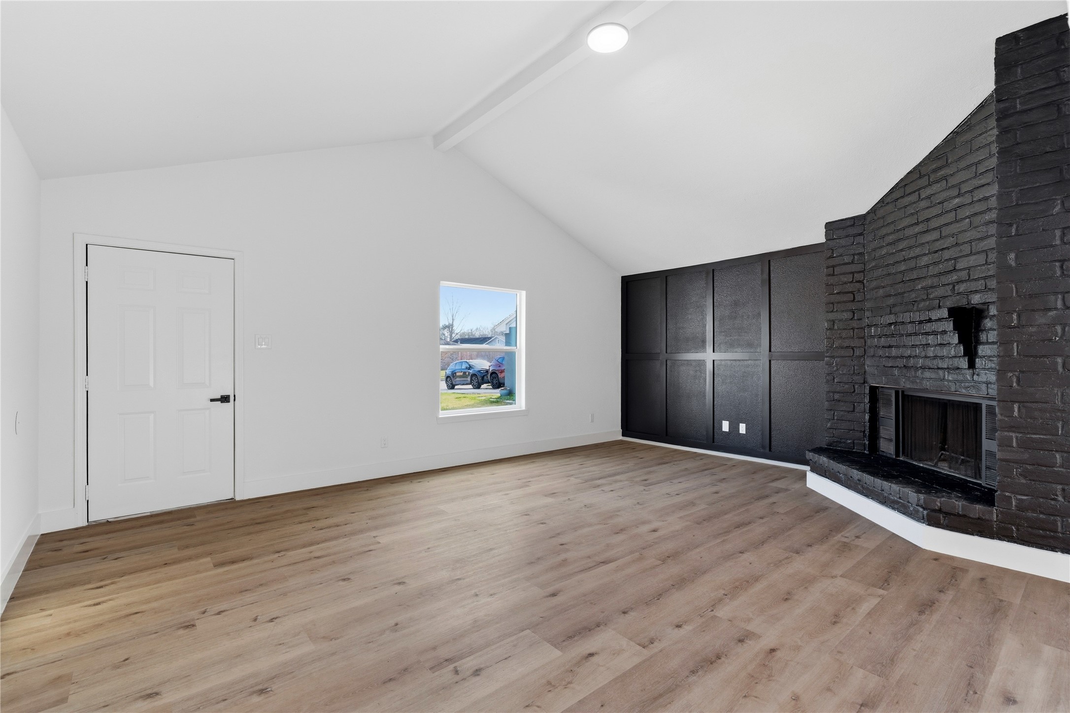 9809 Wren Court Conroe, TX 77385 - Photo 5 of 22 a view of an empty room with wooden floor and a fireplace