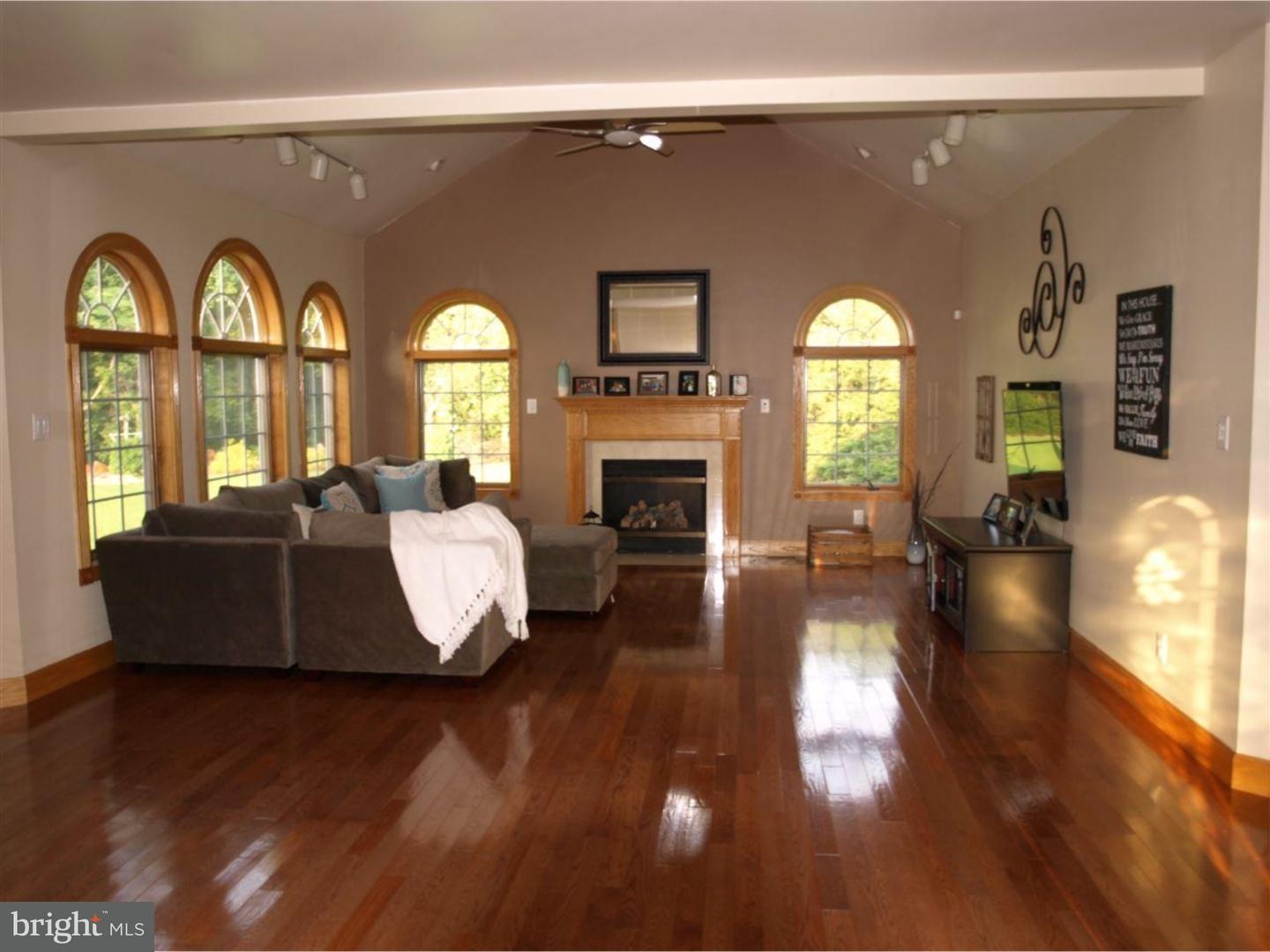 63 Beebe Run Road Bridgeton, NJ 08302 - Photo 8 of 20 a living room with fireplace furniture and a wooden floor