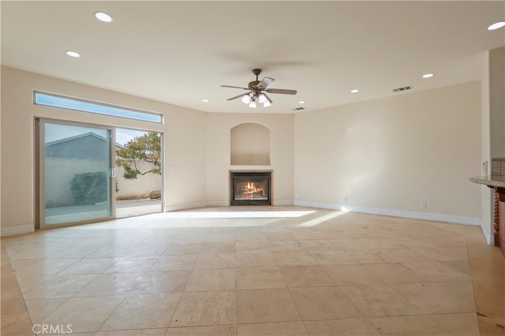 17100 Apple Street Bellflower, CA 90706 - Photo 13 of 38 a view of an empty room with a fireplace and a window