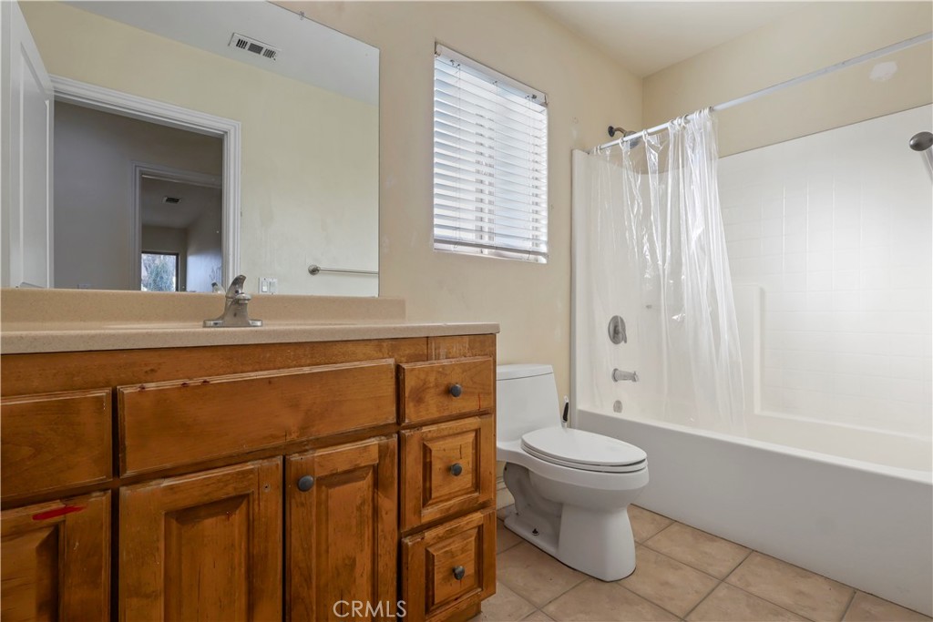 17100 Apple Street Bellflower, CA 90706 - Photo 22 of 38 a bathroom with a granite countertop sink toilet and shower