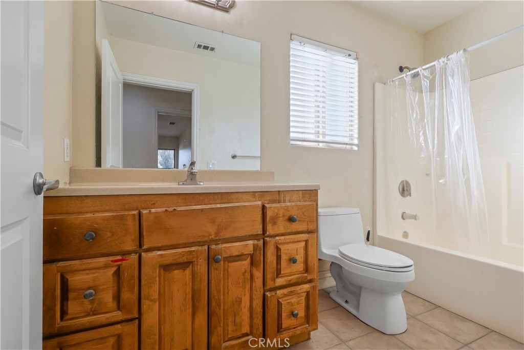 17100 Apple Street Bellflower, CA 90706 - Photo 23 of 38 a bathroom with a sink a toilet and a mirror